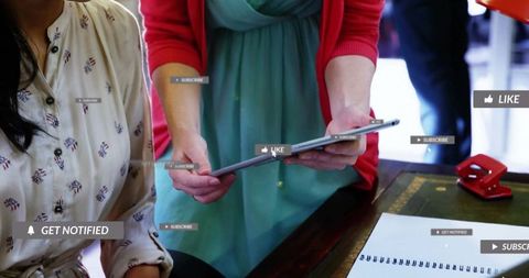 Woman Presenting Social Media Metrics Using Tablet in Office Meeting