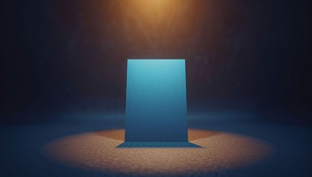 Blue monolith under warm spotlight on textured floor