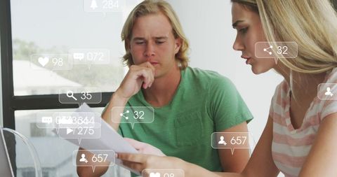 Couple Engaged in Financial Planning with Social Media Overlay