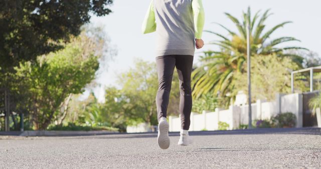 Person Jogging in Outdoor Suburban Neighborhood on Sunny Day - Download Free Stock Images Pikwizard.com