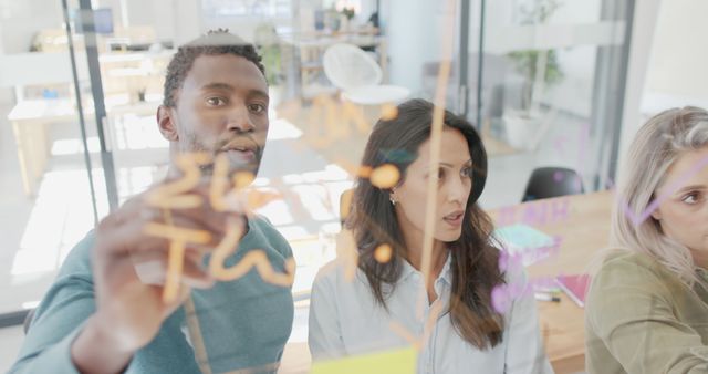 Diverse Team Brainstorming Ideas on Glass Board in Modern Office - Download Free Stock Images Pikwizard.com