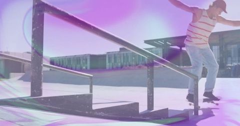 Vibrant skateboarder grinding on handrail midday