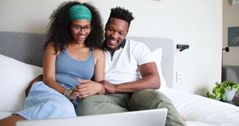 Happy Couple Sharing Baby News on Video Call at Home