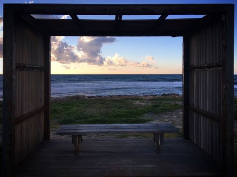 Rustic wooden shelter with beach sunset view