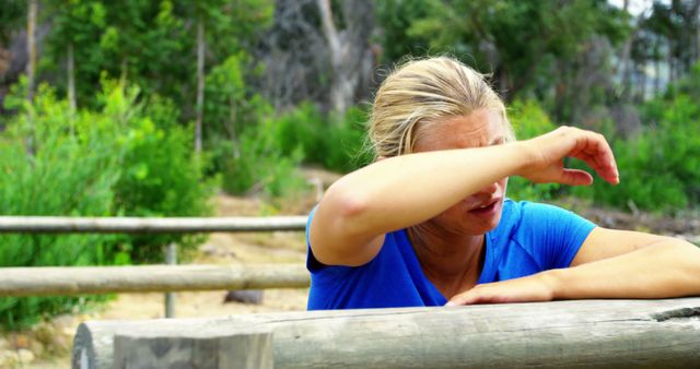 Tired woman taking a break outdoors after exercise - Download Free Stock Images Pikwizard.com