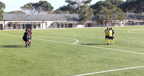 Soccer Teams Discussing Strategies Before Friendly Match