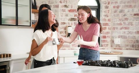 Friends celebrating pregnancy announcement with ultrasound