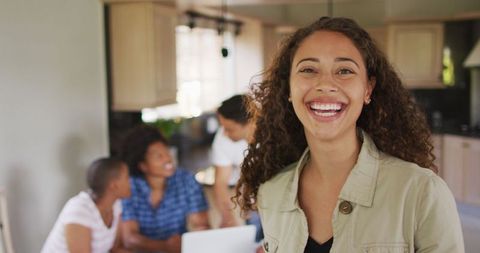 Smiling Biracial Woman with Friends in Cozy Home Kitchen