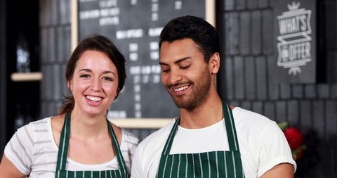 Smiling Colleagues in Aprons Displaying Teamwork in Restaurant Environment - Download Free Stock Images Pikwizard.com