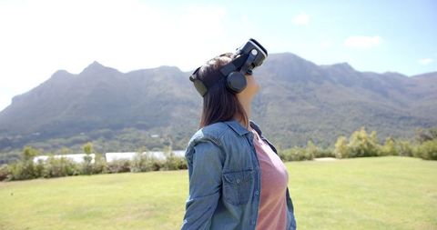 Young Woman Experiencing Virtual Reality Outdoors