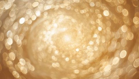 Swirling Golden Bokeh Vortex with Soft Central Glow, Abstract Luxury Background