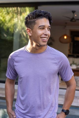 Young Man in Purple Athletic Shirt Enjoying Outdoor Leisure by Pool