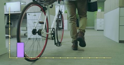 Professional commuter walking bicycle in modern office interior