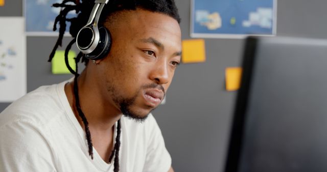 Focused Young Man with Headphones Working at Computer - Download Free Stock Images Pikwizard.com