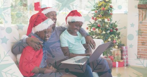 Family Celebrating Christmas with Laptops and Festive Hats