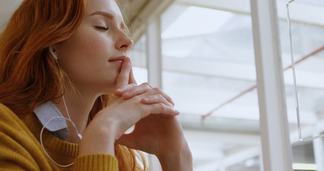 Young Woman Deep in Thought Listening to Music with Earphones - Download Free Stock Images Pikwizard.com