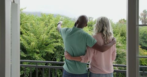 Romantic Couple Embracing on Balcony with Scenic View