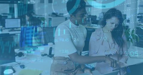 Women Analyzing Data on Tablet in Modern Office Environment