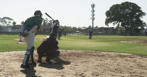 Competitive baseball game: batter, catcher, and umpire in action