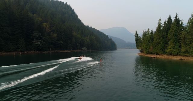 Boat Water Skiing in Serene Mountain Lake - Download Free Stock Images Pikwizard.com