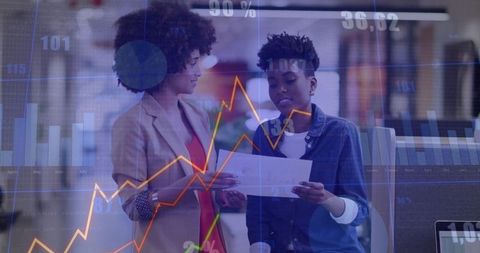 Businesswomen Analyzing Data with Charts and Graphs Holographically