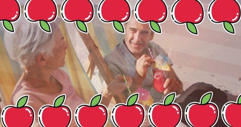 Senior couple enjoying beach time with refreshing drinks