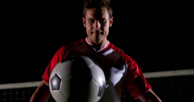 Focused Soccer Player Balancing Ball in Dark - Download Free Stock Images Pikwizard.com