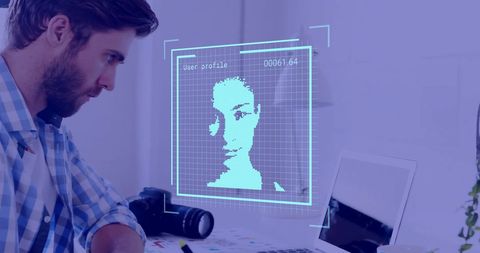 Businessman analyzing facial recognition technology on computer
