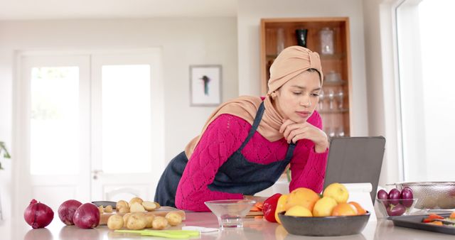 Woman in Kitchen Wearing Headscarf Using Tablet Cookbook - Download Free Stock Images Pikwizard.com