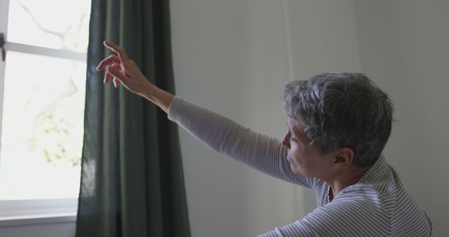 Senior Woman Stretching Arm Towards Window - Download Free Stock Images Pikwizard.com