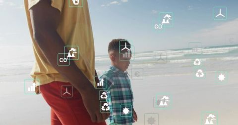 Father and son walking on sunny beach with eco icons, wind turbine and recycling symbols