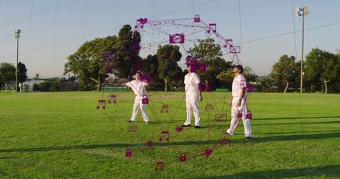 Three cricketers standing on sunlit park wearing white kits with magenta network overlay