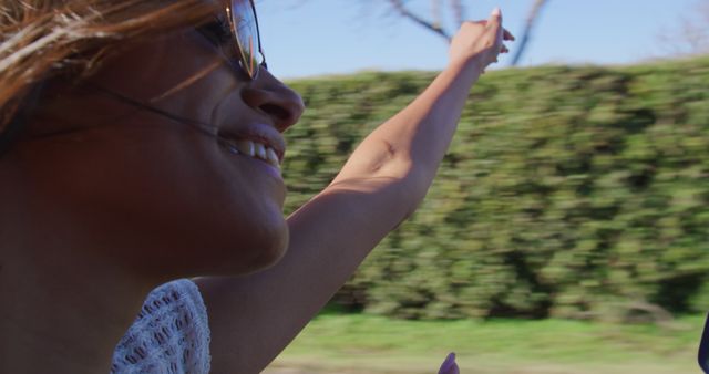 Young Woman Enjoying Summer Road Trip with Hand Outstretched - Download Free Stock Images Pikwizard.com