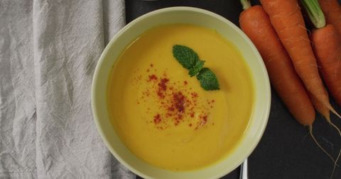 Delicious creamy carrot soup with fresh garnish