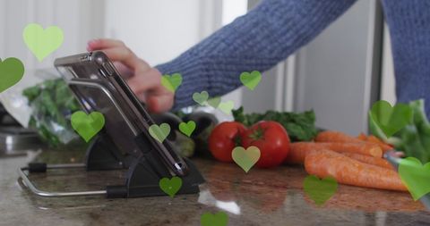 Man Cooking with Tablet Surrounded by Digital Hearts