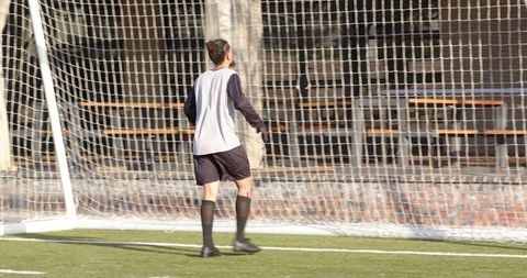 Young Soccer Player Practicing Goalkeeping at School Field