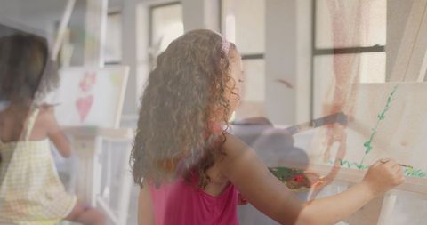This image captures schoolgirls engaged in painting activities in an art class, promoting creativity and education. It highlights the diverse makeup of a classroom and the importance of artistic expression among children. Suitable for educational resources, creative workshops, and child development campaigns.