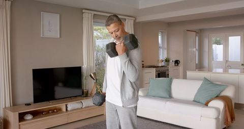 Senior Man Engaging in Home Exercise with Dumbbells
