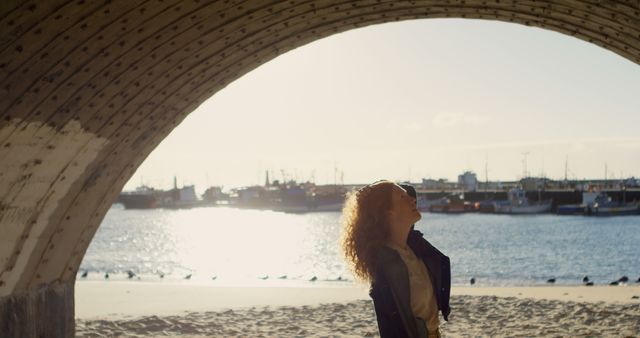 Woman enjoying seaside view under archway structure - Download Free Stock Images Pikwizard.com