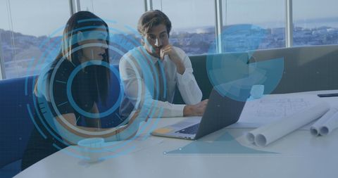 Diverse Business Team Analyzing Digital Data with Futuristic Overlay