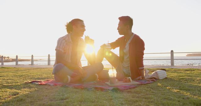 Couple Enjoying Picnic at Sunset by the Sea - Download Free Stock Images Pikwizard.com