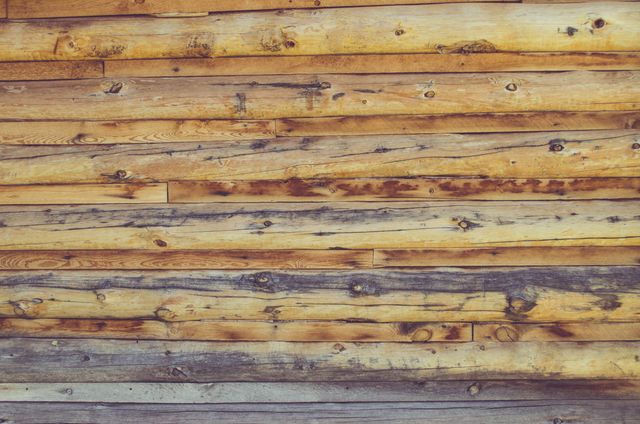 Rustic wooden plank wall showcasing natural texture and knots. Ideal for backgrounds, websites, advertisements, and rustic-themed projects. Offers a warm, vintage look perfect for interior design ideas or woodworking displays.