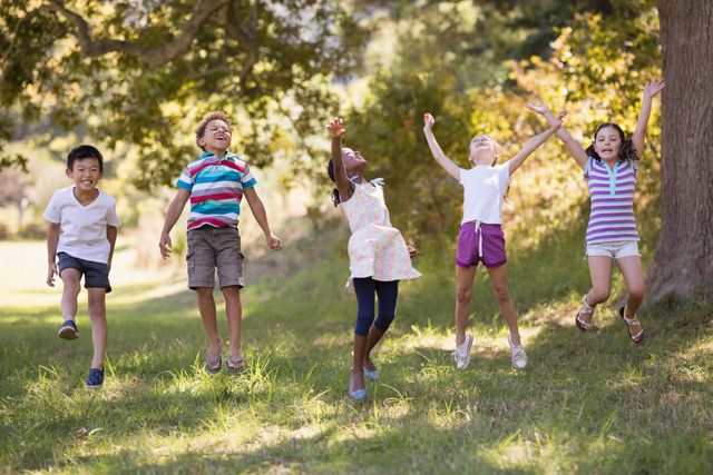 Cheerful Children Jumping in Forest - Download Free Stock Photos Pikwizard.com