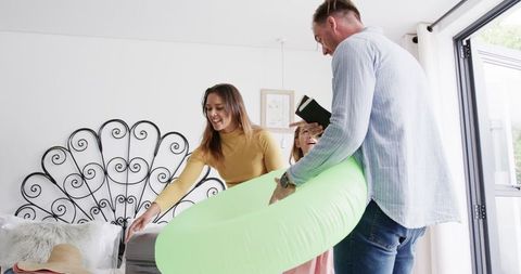 Happy family packing for summer getaway with inflatable float