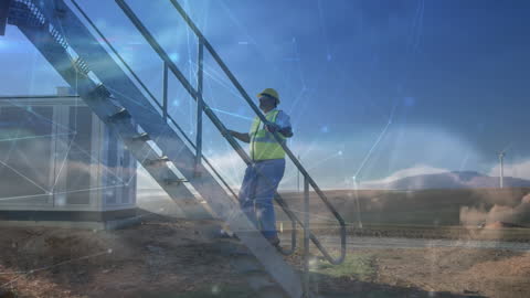 Technician Climbing Steps at Wind Farm with Digital Overlay