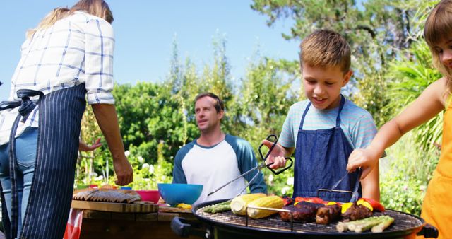 Kids grilling meat and vegetables on barbecue in the house garden