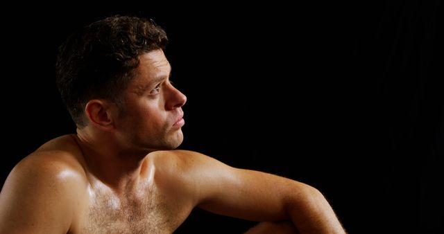 Contemplative Shirtless Man in Low Light Profile - Download Free Stock Images Pikwizard.com