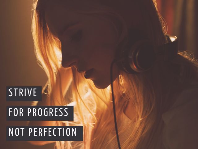 Perfect for self-help blogs, motivation cards, inspirational posters. Depicts determined young woman with headphones, highlighted by warm lighting, emphasizing focus on progress over perfection.