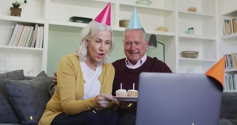 Happy senior couple celebrating a virtual birthday celebration