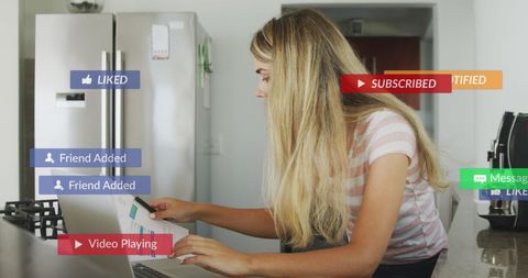 Young Woman Checking Social Media Notifications in Kitchen